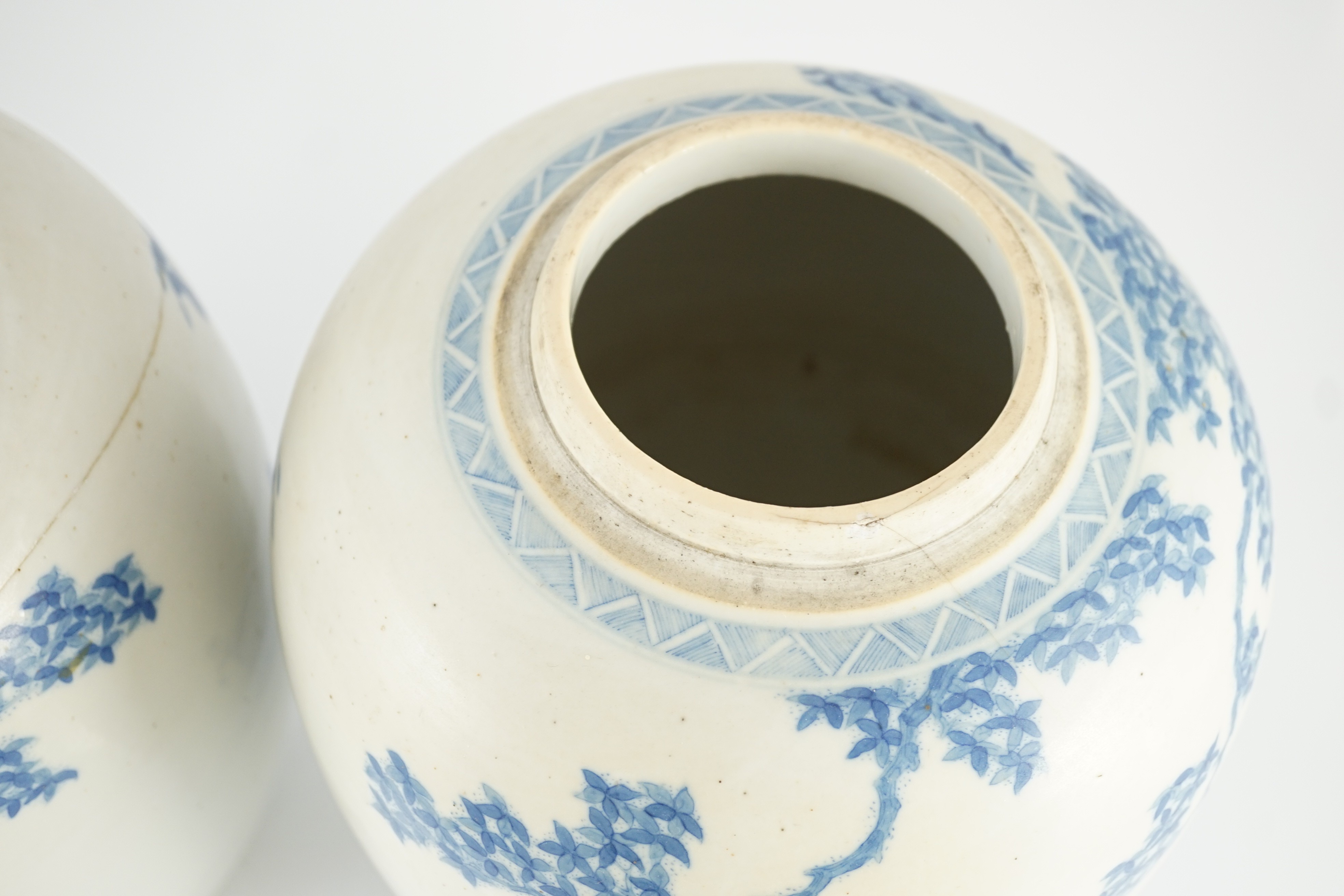 A pair of large Chinese blue and white ovoid jars and associated covers, 19th century, 34.5cm high, damage and repairs